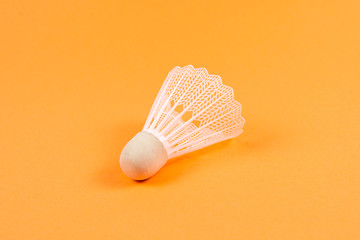 Shuttlecock on orange background.