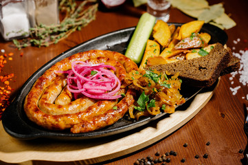 Fried potato and bavarian sausage.Top view