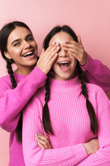 Two cheerful cute teenage girls having fun isolated