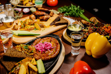 Many different delicious dishes on the table. Various snacks and antipasti on the table. Restaurant menu.