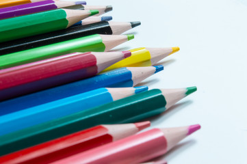 Close-Up Of Multi Colored Pencils Over White Background