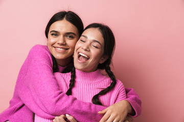 Two cheerful cute teenage girls having fun isolated