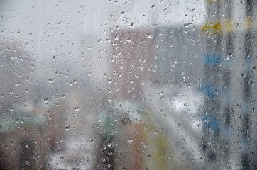 The view from the window through the misted window. Raindrops.