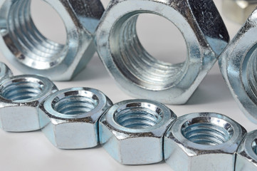 Big and small screw-nut. Concept. White background.