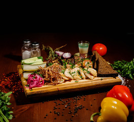 Barbecue ribs, and french fries with sauce on a wooden plate. Dish with a lot of fried meat.