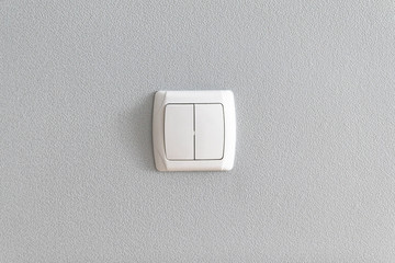 Simple light switch on grey wall. Electrical point of power in house