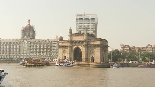 Gateway of India and Taj Mahal Palace in Mumbai, filmed from departing boat.