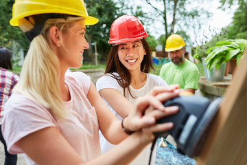 Two young women with grinder