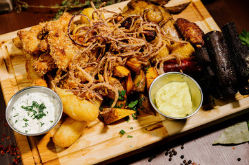 Selection of beer and snacks.Chips, fish, beer sausages on the table