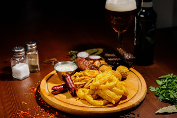 Selection of beer and snacks.Chips, fish, beer sausages on the table