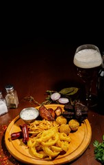 Selection of beer and snacks.Chips, fish, beer sausages on the table
