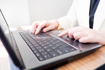 Cropped shot view of business woman’s hands typing the labtop with blank copy space screen for your information content or text message