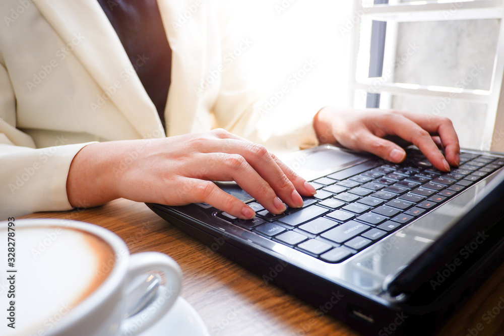 Fototapete Cropped shot view of business woman’s hands typing the labtop with blank copy space screen for your information content or text message