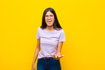 young pretty latin woman looking angry, annoyed and frustrated screaming wtf or what‚Äôs wrong...