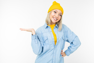 blond girl in a casual look with holding hand on a white background