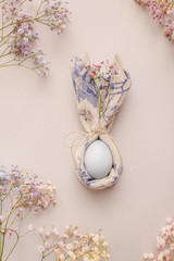 Easter egg in a napkin. Napkin draped under rabbit ears.