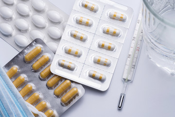 A bunch of blister packs of tablets, pills coronavirus. flu and cold medications. Copy space, Close...