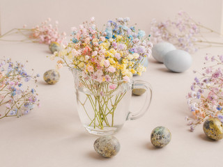 Hand painted Easter egg on a background of multicolored pastel flowers.