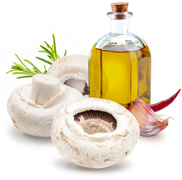 Raw mushrooms, with chillies, olive oil and freco rosemary (champignon, cut foot, Agaricus Bisporus). Isolated on white background.