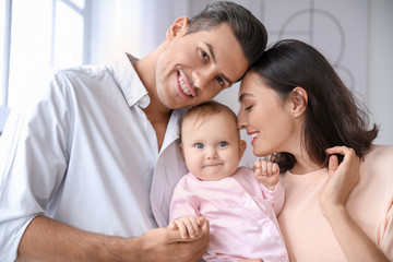 Cute baby with parents at home