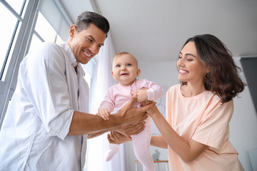Cute baby with parents at home