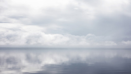 Reflection of grey clouds in lake water