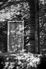A view of the brick wall with the old door