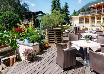Fototapeta na wymiar Street restaurant with table and chairs in Bad Kleinkirchheim Austria