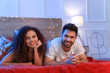 Happy young couple in bedroom