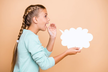Profile photo of beautiful excited little lady hold empty paper cloud saying whispering dialogue answer hand near mouth wear blue sweater isolated beige pastel color background