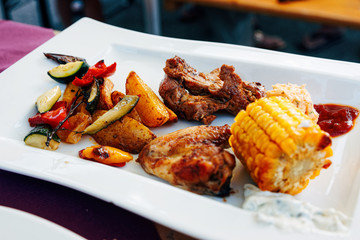 Meat potato and vegetables on white plate