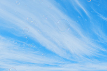 Colorful Soap Bubbles Against Blue Sky Background