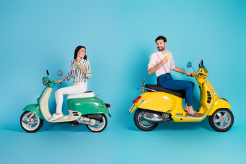 Full length profile side photo positive two people wife husband sit yellow motor bike use smartphone find adventure journey location wear formalwear shirt pants isolated blue color background