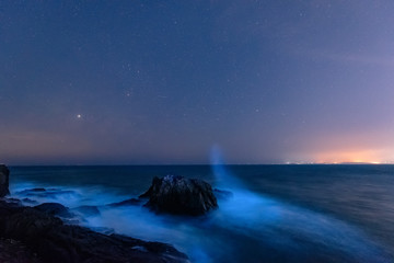 Seaside, beautiful starry sky and blue waves