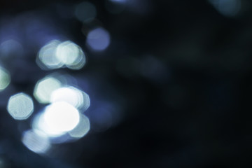 Bokeh defocused blue background. Abstract shiny illuminated night in town backdrop with copy space