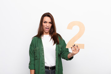 young pretty woman angry, anger, disagreement, holding a number 2.