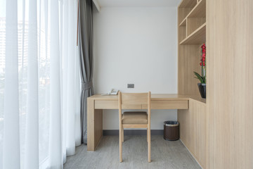 Modern wooden work desk and telephone with wooden cabinet interior decoration