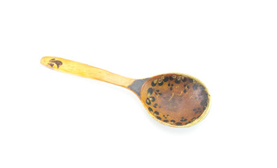 Old shabby wooden spoon handmade brown. Vintage scratched food accessory on a white isolated background.