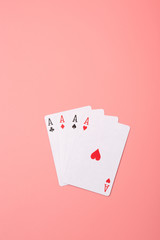 Expanded playing cards on pink background