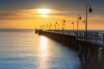 Fototapeta premium Beautiful landscape with wooden pier in Gdynia Orlowo at sunrise, Poland