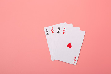 Expanded playing cards on pink background