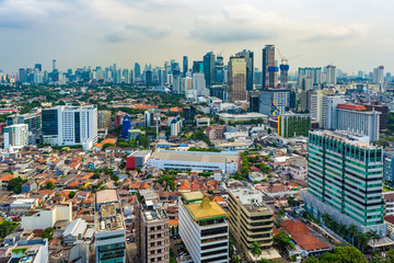 Jakarta, Indonesia - 19th Feb 2019: Aerial or bird eye view of Jakarta Central Business District (Sudirman and Kuningan). Rich and poor inequality. Taken at a cloudy afternoon.