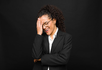 young black woman laughing and slapping forehead like saying d‚Äôoh! I forgot or that was a...