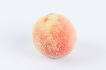 One or cut peaches on a white background