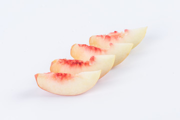 One or cut peaches on a white background