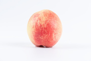 One or cut peaches on a white background