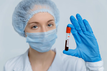 Nurse holds test tube with blood sample. Coronavirus outbreaking, MERS Wuhan, China.