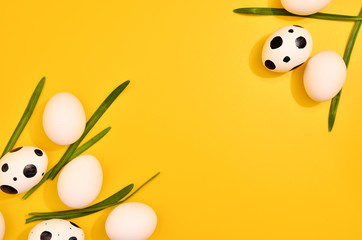Many White eggs with green myrtle leaves pattern on yellow color background. Spring and Easter...
