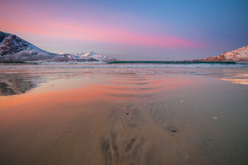 Fototapeta premium Amazing sunrise with amazing magenta color over sand beach. Tromso, Norway . Polar night. long shutter speed