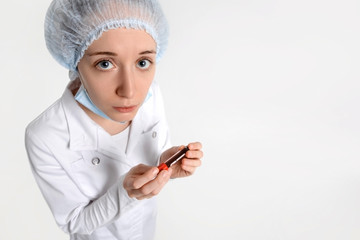 Nurse on white background with blood sample looks at you with empathy. Coronavirus outbreaking, MERS Wuhan, China.